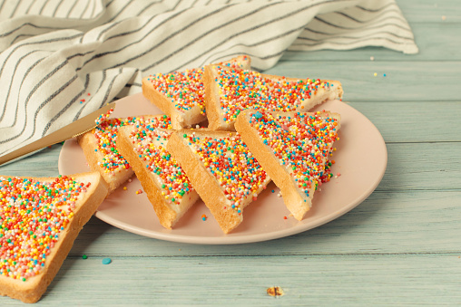Famous traditional Australian party food Fairy Bread on blue background.