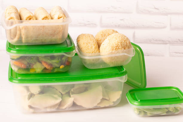 istock Frozen convenience foods and vegetables in plastic containers on a white table 1370280685