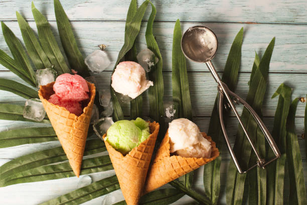 istock ice cream on a blue table with a palm leaf. Pastel ice cream in waffle cones, bright background, copy space 1370280717