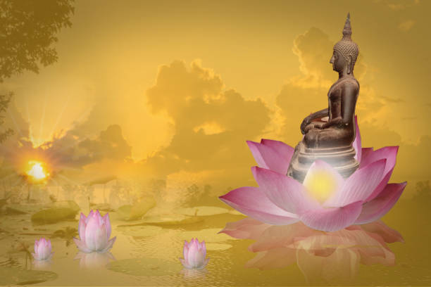 istock Buddha statue sitting on a pink lotus flower. 1370280972