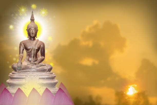 istock Buddha statue sitting on a pink lotus flower. 1370280973