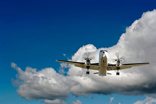 istock XL propeller airplane landing in cloudy sky 137028326