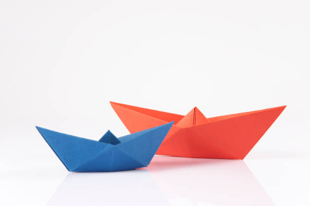 istock Red and Blue Paper Boats 1370284580