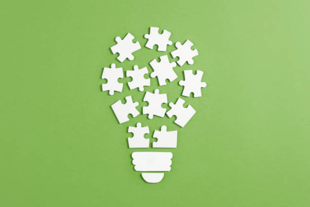 Idea Light Bulb Puzzle on Orange Colored Background stock photo