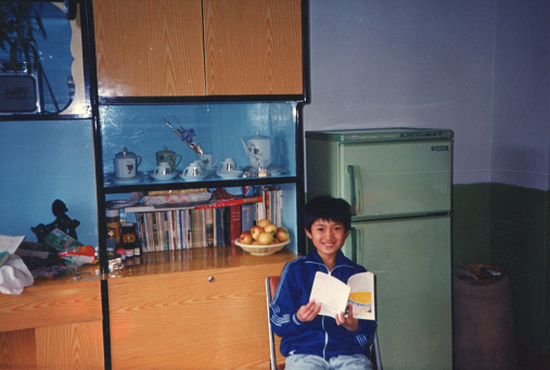 1980s Chinese Little Boy Reading in Home Old Photo of Real Life