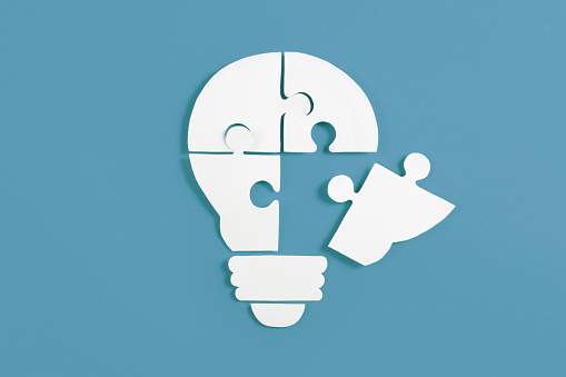 Idea Light Bulb Puzzle on Blue Background