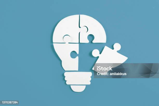 Idea Light Bulb Puzzle On Blue Background Stock Photo - Download Image Now - Whole, Finishing, Business