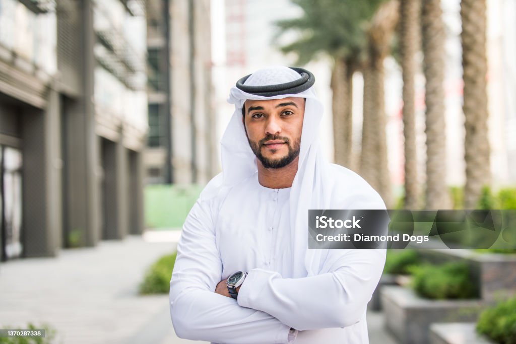 Arabic businessman with kandura Arabian businessman portrait - Middle-eastern bearded adult wearing traditional emirates kandora United Arab Emirates Stock Photo