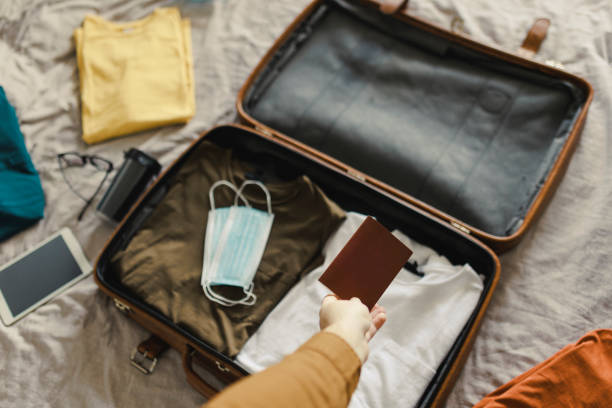 istock All packed and ready to go, High angle shot of a suitcase packed with various essentials for a traveling businessman 1370288242
