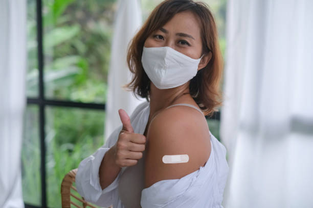 Mature Asian Woman Getting Vaccinated
