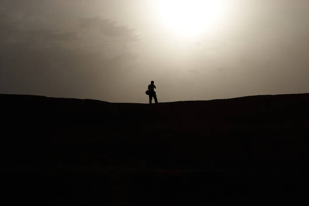 istock A man facing against the sun at the desert in Iran 1370292224