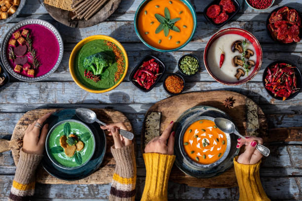 istock Prepared dining table with starters and vegetable soups. Vegetable soups on the old cutting boards. 1370292479