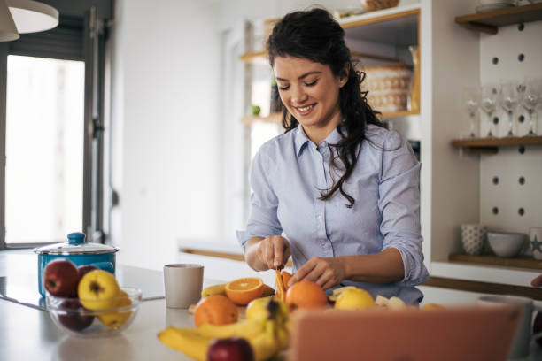istock Beautiful woman in the kitchen. 1370293933