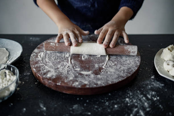 istock An Asian boy cooking with joy in kitchen. 1370294047