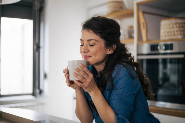 istock Beautiful woman in kitchen. 1370294912