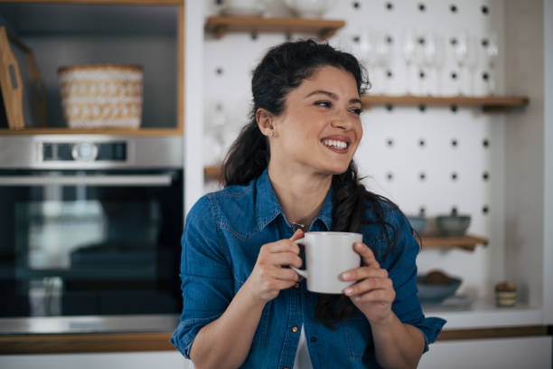 istock Beautiful woman in kitchen. 1370294918