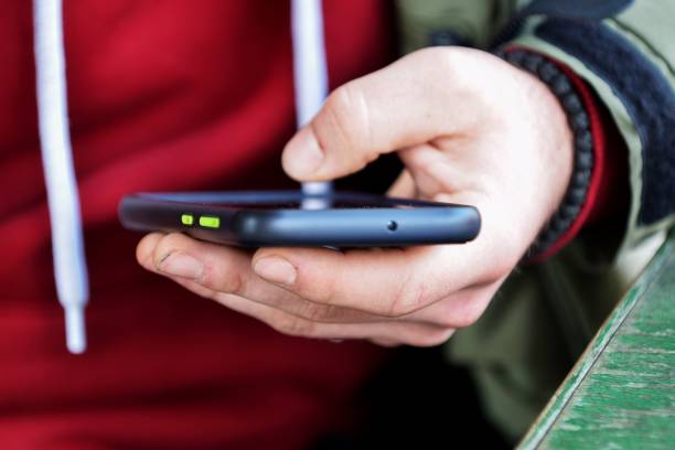 istock Close up of a man using mobile smart phone 1370296423
