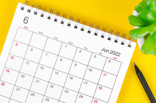 istock June 2022 desk calendar on yellow background. 1370298044