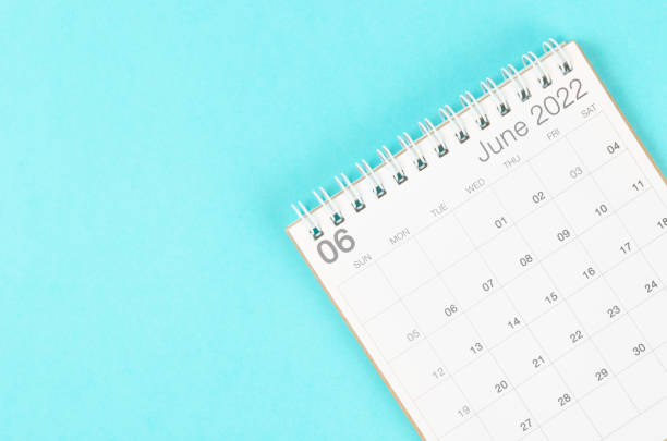 istock June 2022 desk calendar on blue background with empty space. 1370298582