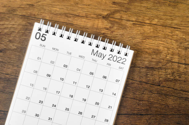 istock May 2022 desk calendar on wooden background. 1370298584