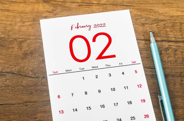 istock February 2022 calendar with pen on wooden table. 1370298630