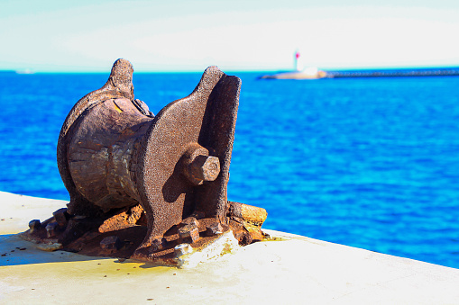 old and rusty port bollard to moor ships