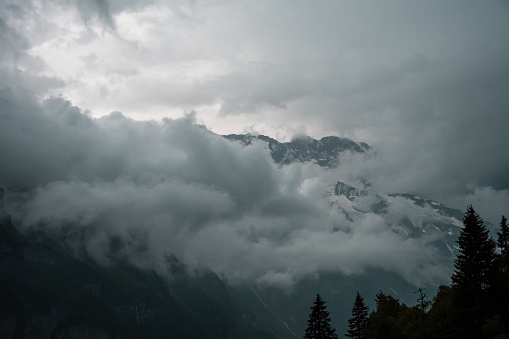 Gloomy dramatic mountain landscape. Atmospheric highland scenery in bad cloudy weather
