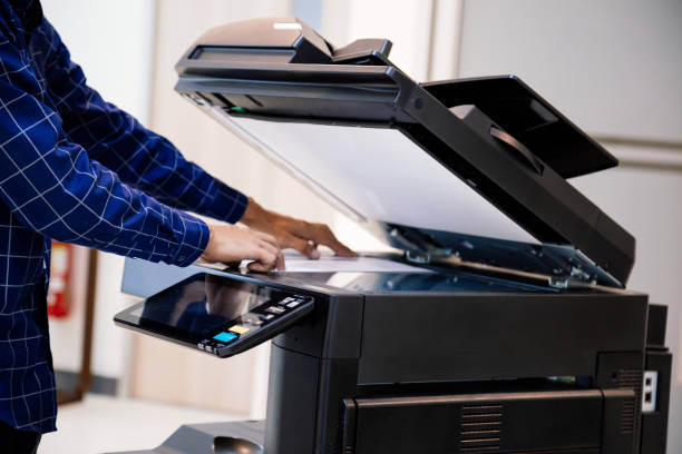 istock Businessmen press button on the panel for using photocopier or printer for printout and scanning document paper at office. 1370302171