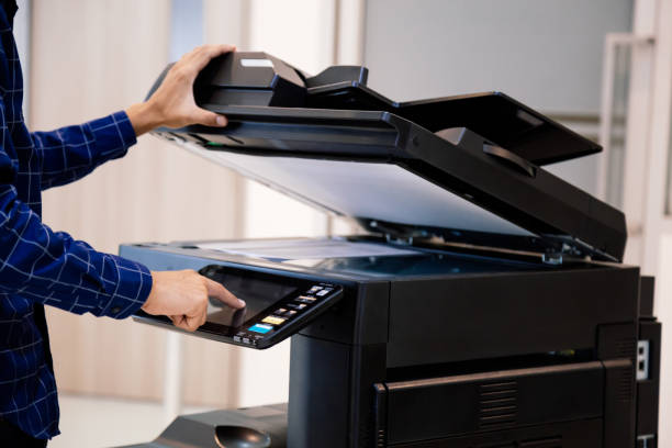 istock Businessmen press button on the panel for using photocopier or printer for printout and scanning document paper at office. 1370302186