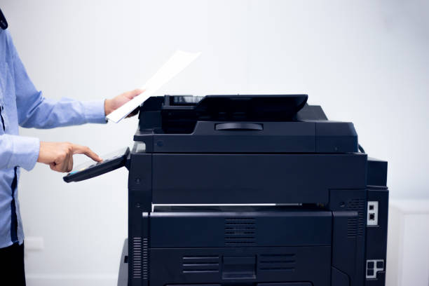 istock Bussiness man Hand press button on panel of printer, printer scanner laser in office copy machine supplies start concept. 1370302269