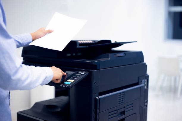 istock Bussiness man Hand press button on panel of printer, printer scanner laser in office copy machine supplies start concept. 1370302275