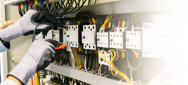 istock Electrical engineers test electrical installations and wiring on protective relays, measuring them with a multimeter. 1370302298