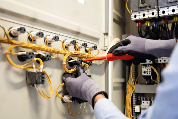 istock Electricians work to connect electric wires in the system, switchboard, electrical system in Control cabinet. 1370302842