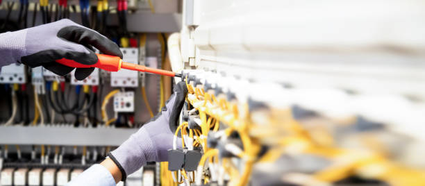 istock Electricians work to connect electric wires in the system, switchboard, electrical system in Control cabinet. 1370302844