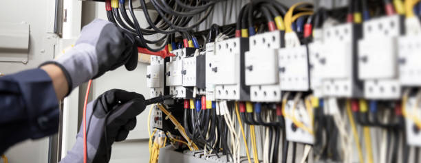 istock Electrician engineer tests electrical installations and wires on relay protection system. Adjustment of scheme of automation and control of electrical equipment. 1370302858