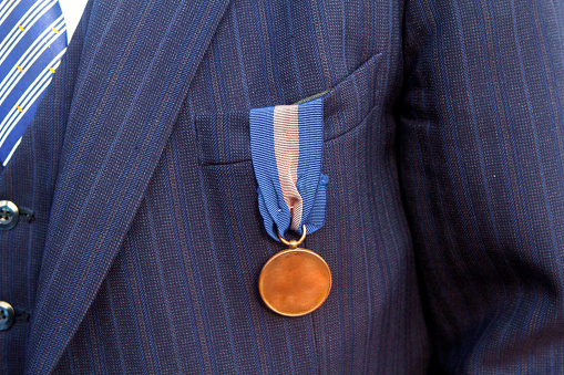 On jacket, a bronze medal for a war hero at WORLD WAR II