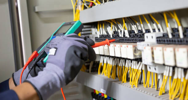 istock Electrician engineer tests electrical installations and wires on relay protection system. Adjustment of scheme of automation and control of electrical equipment. 1370302899