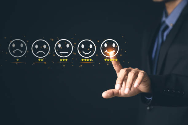 istock Customer Service and Satisfaction Concept Businessmen touch the virtual screen on happy smiley icons to achieve service satisfaction and feedback with excellent rated reviews. 1370302985
