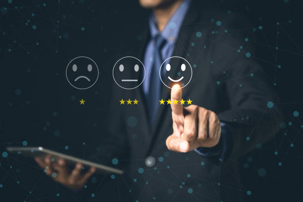 istock Customer Service and Satisfaction Concept Businessmen touch the virtual screen on happy smiley icons to achieve service satisfaction and feedback with excellent rated reviews. 1370302986