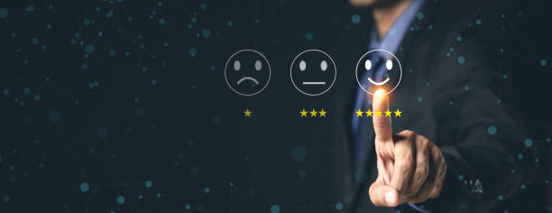 istock Customer Service and Satisfaction Concept Businessmen touch the virtual screen on happy smiley icons to achieve service satisfaction and feedback with excellent rated reviews. 1370302993