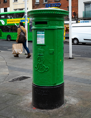 A green-painted traditional post office pillar box on Dame St in Dublin, Ireland, dating from the reign of British King Edward VII (1901-10).
Following the Anglo-Irish Treaty of 1921 the new government of the Irish Free State immediately painted the British red letter boxes green as a visual mark of the country's new independent identity. 