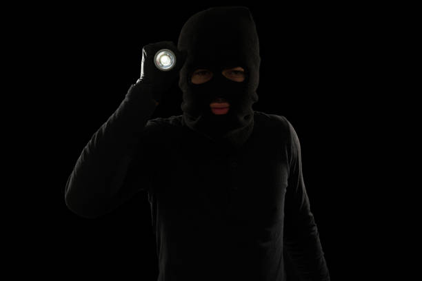 istock Portrait of a criminal with a flashlight 1370303607