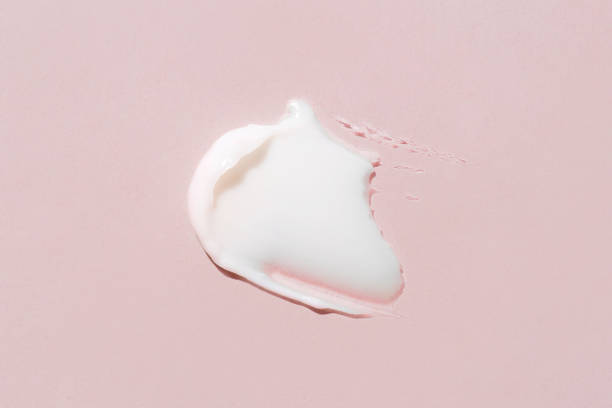 istock Smear of cream on a pink background. 1370304120