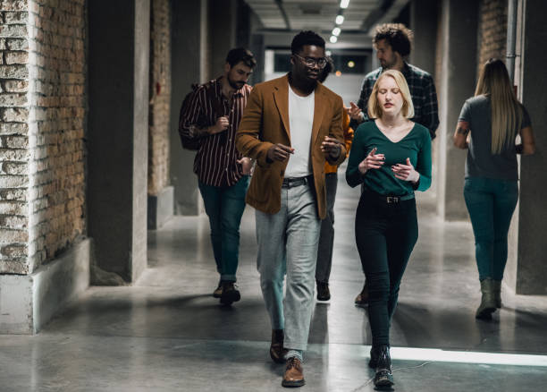 istock Young Business  people discussing and smiling while walking together 1370305045