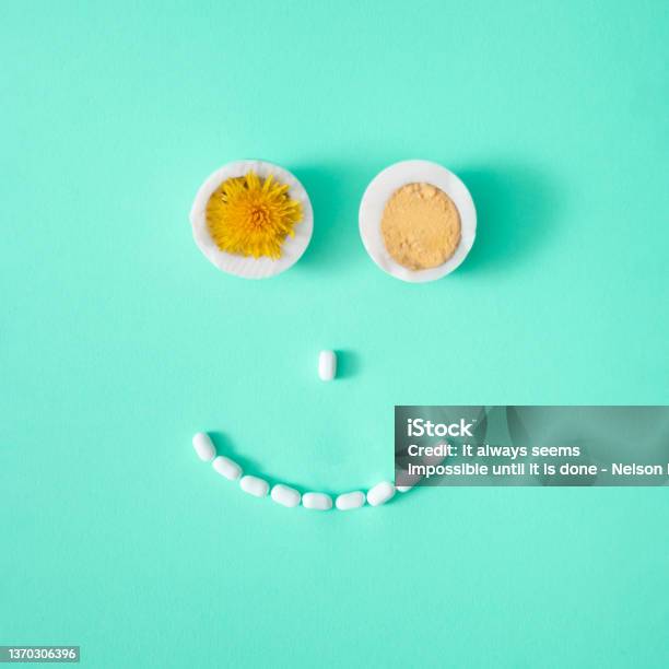 Smiling Face Made Of Boiled Eggs Yellow Flower And Candy On Light Pastel Green Background Creative Concept Flat Lay Stock Photo - Download Image Now