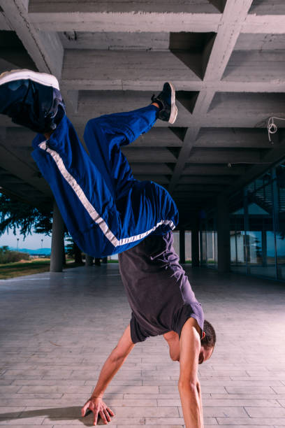 istock Young parkour man perform handstand at urban place 1370306645