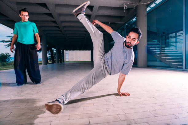 istock Two friends training parkour together at urban place 1370306652