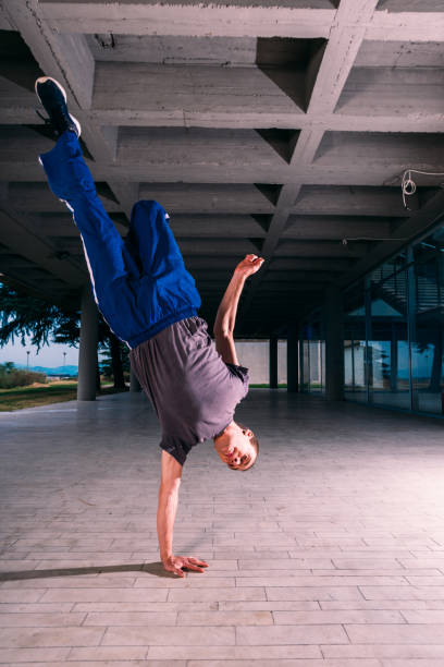 istock Young man exercising handstand at urban place 1370306657