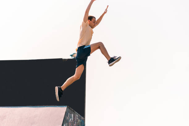 istock Parkour guy while jumping of the wall outdoors 1370306693