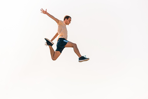 Sports man training parkour while jumping in the air